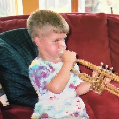Eli as a kid playing the trumpet